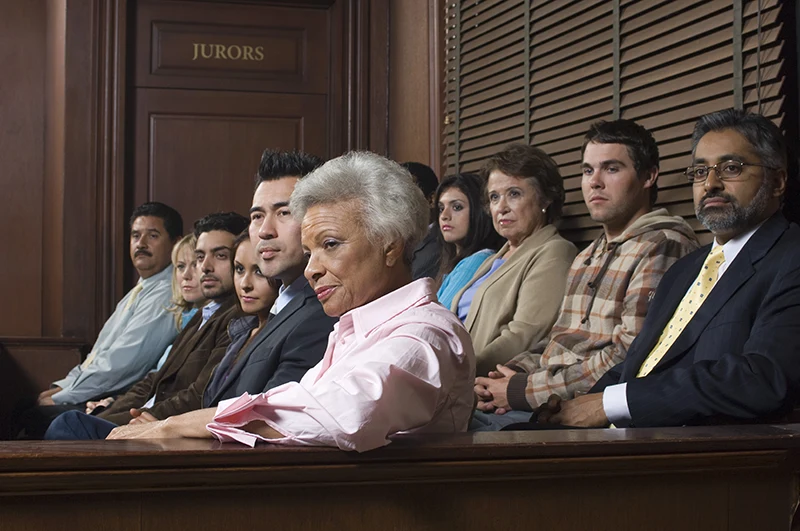 A twelve-person jury watching court proceedings